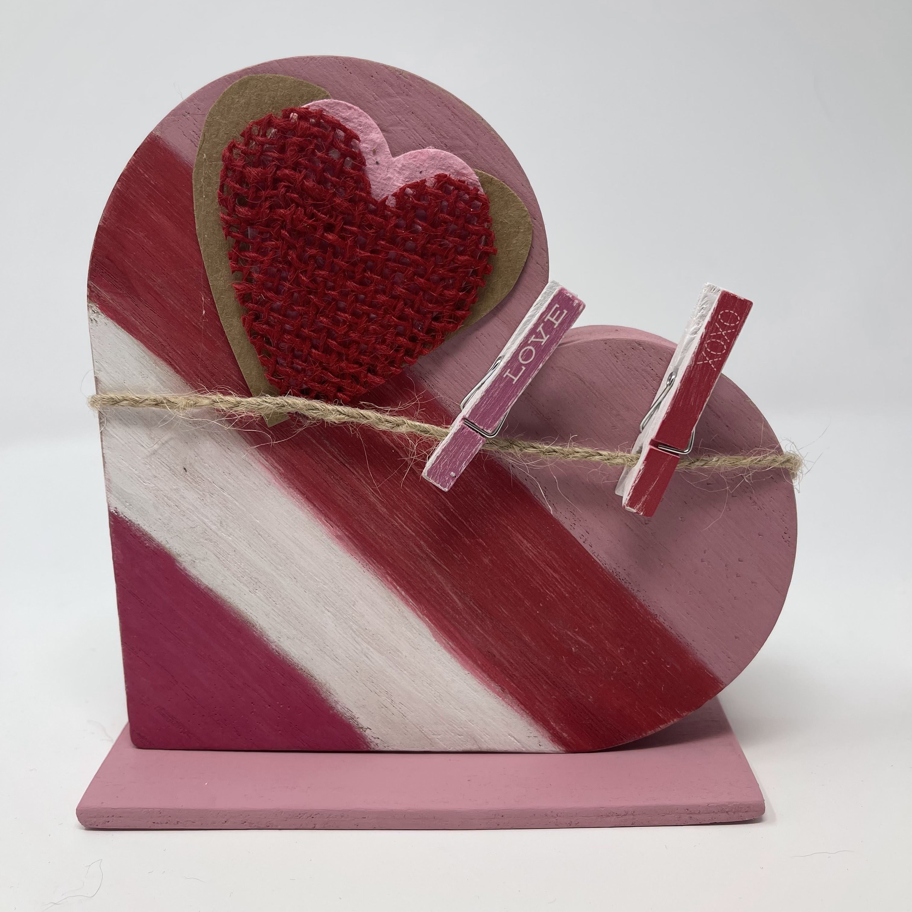 #10 Pink, white, and red striped heart standing on side with two small clothespins for display. 6x6x3"