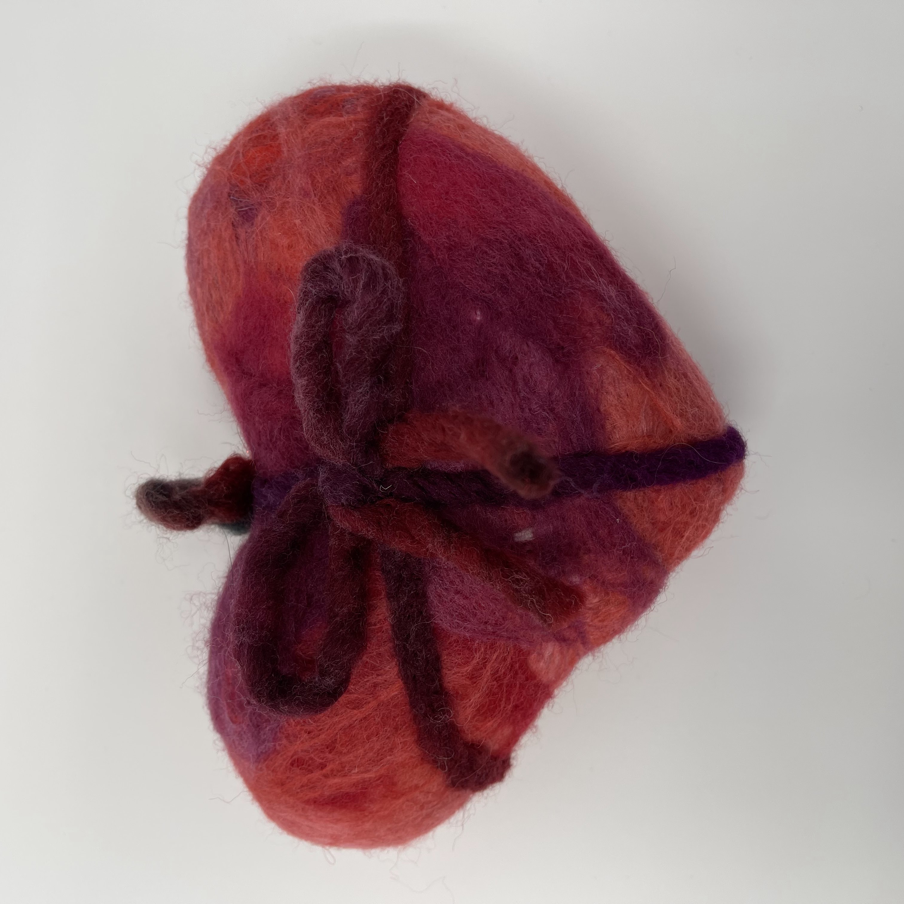 #14 Stuffed pink, purple and red felted heart with purple bow detail. 5x8x2.5"