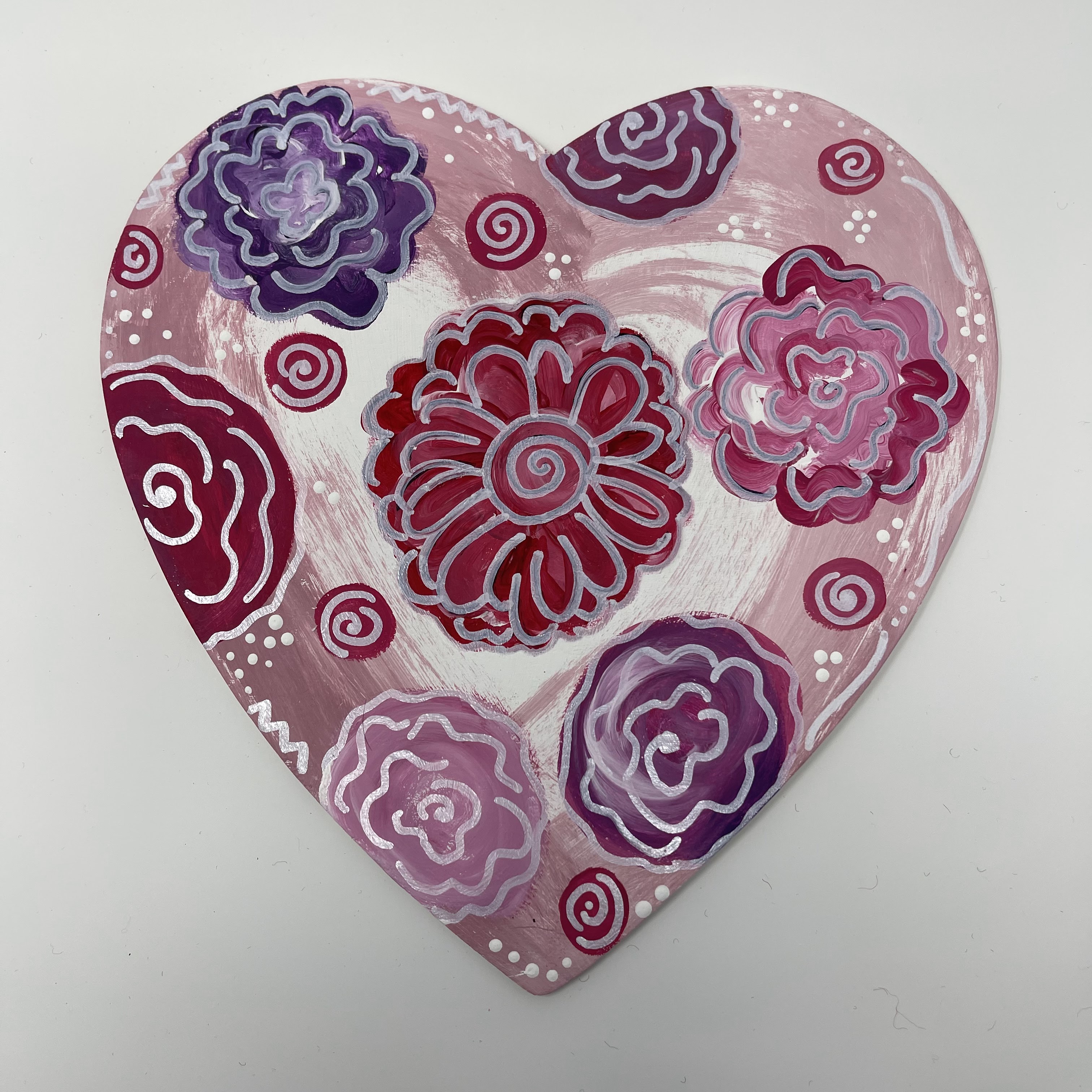 #28 Wood painted heart. Red, pink, and purple swirled flower designs. 9x9x0.1"