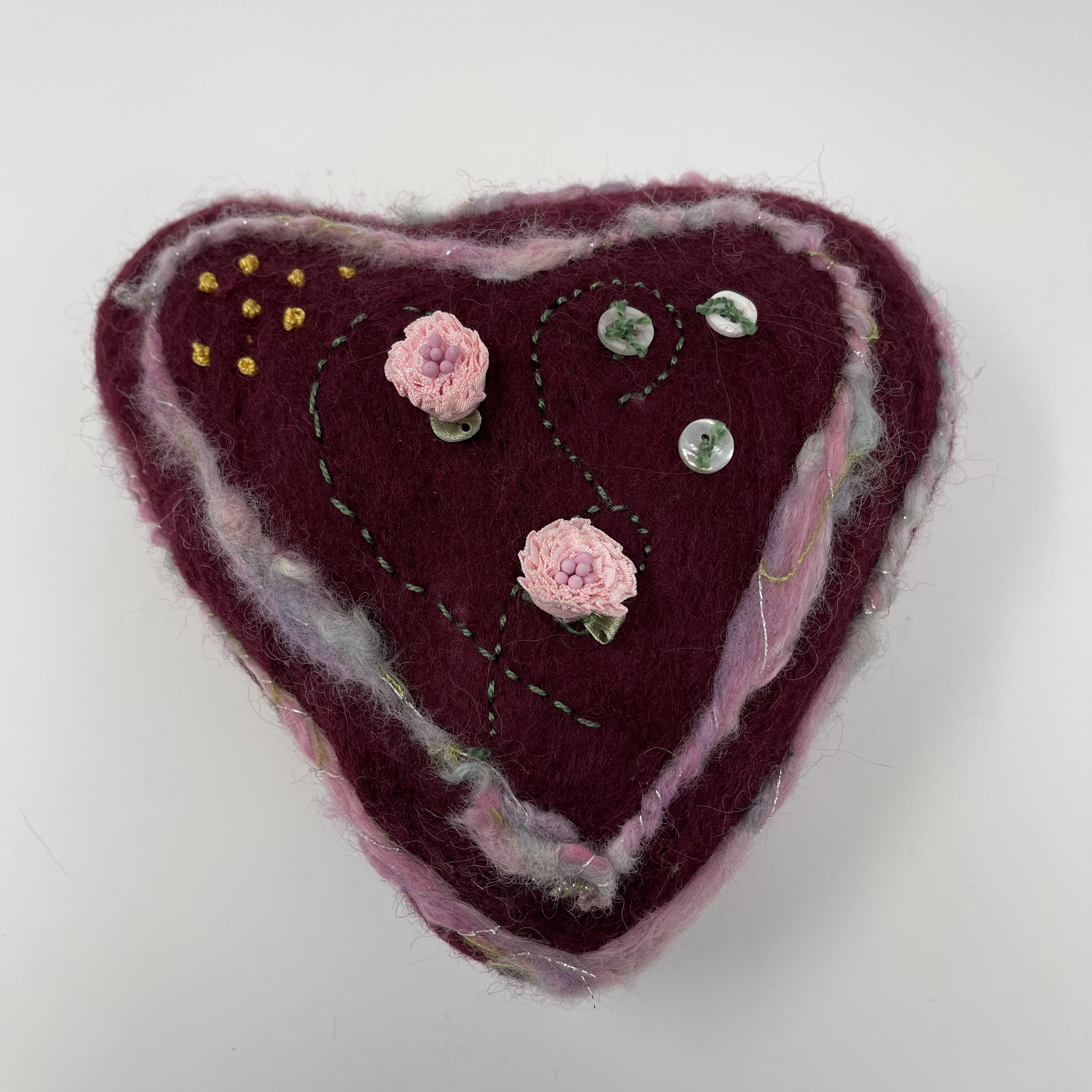 #43 Stuffed felted heart. Burgundy with pink handspun wool and buttons and flowers. 9x9x5"