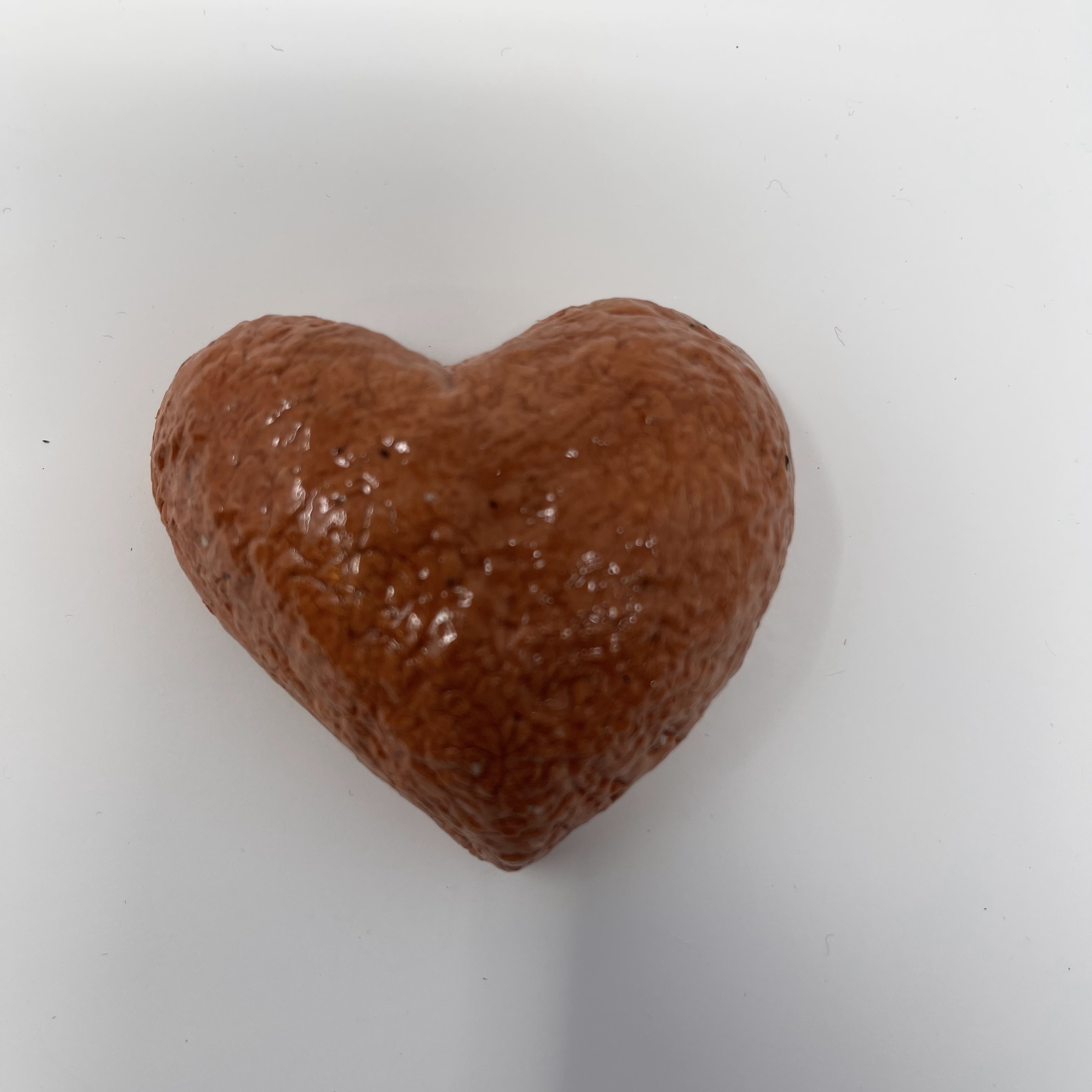 #44 Glazed red clay heart with textured pattern. 2x3x1"