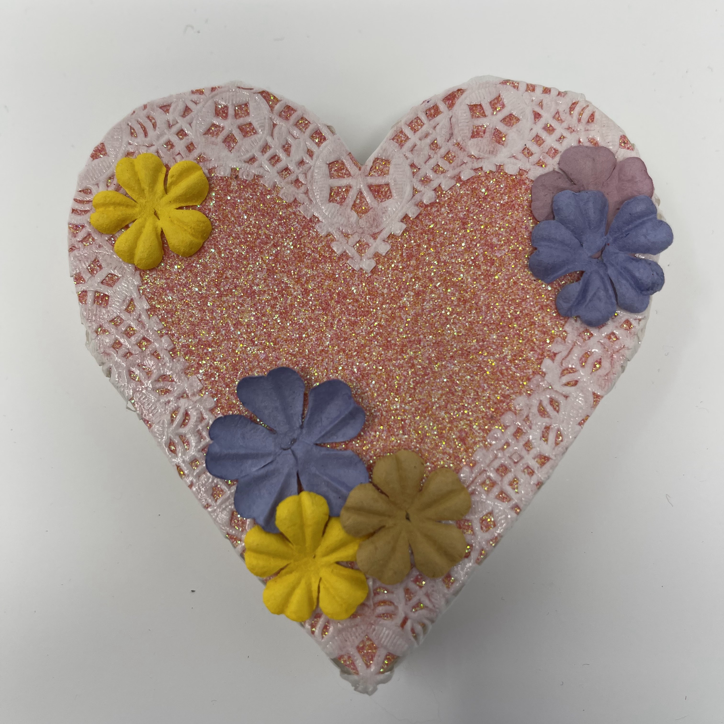 #46 Wood heart decoupaged with paper doilies, sparkle paper, and blue and yellow flowers. 4x4x1"