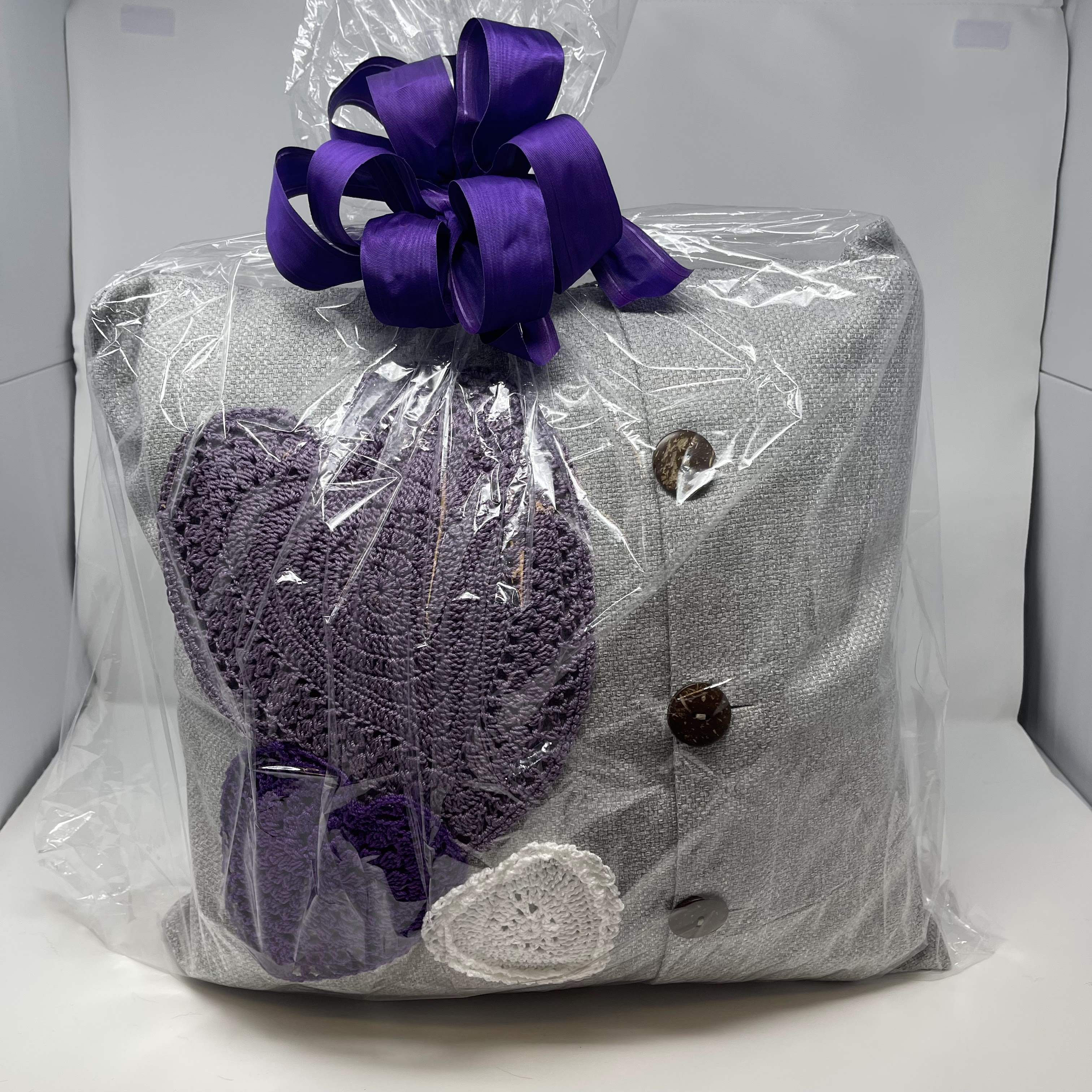 #51 Grey woven fabric pillow with buttons on front decorated with heart shaped crocheted doilies in white and purple. 15x15x8"