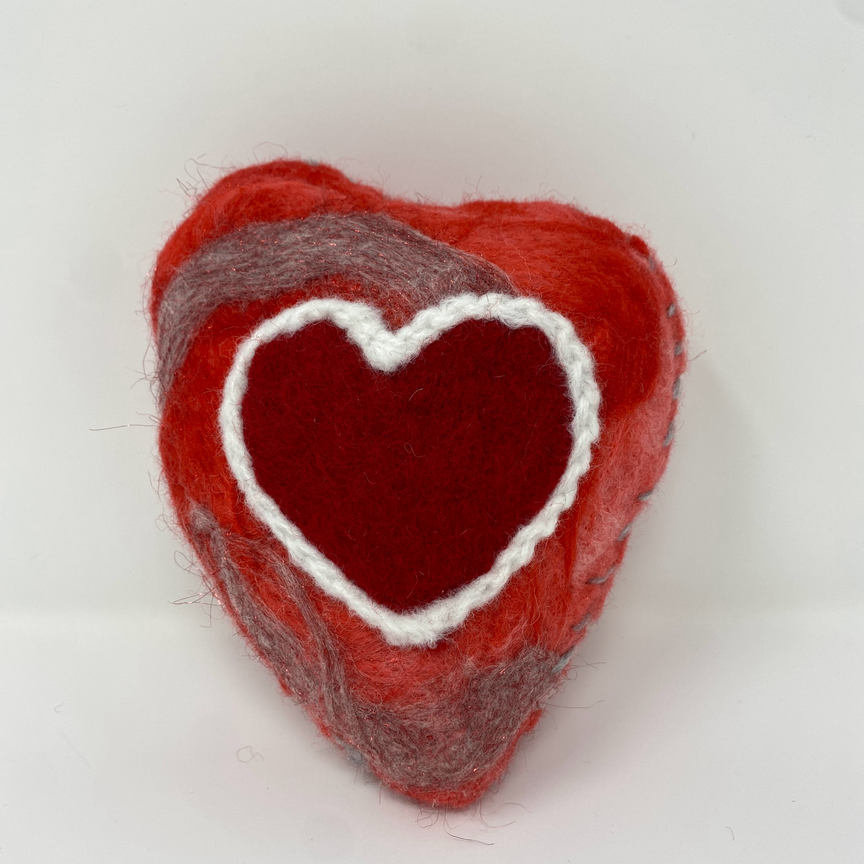 #55 Stuffed felted red heart with shimmering grey detail and red needle felted heart design with white outline