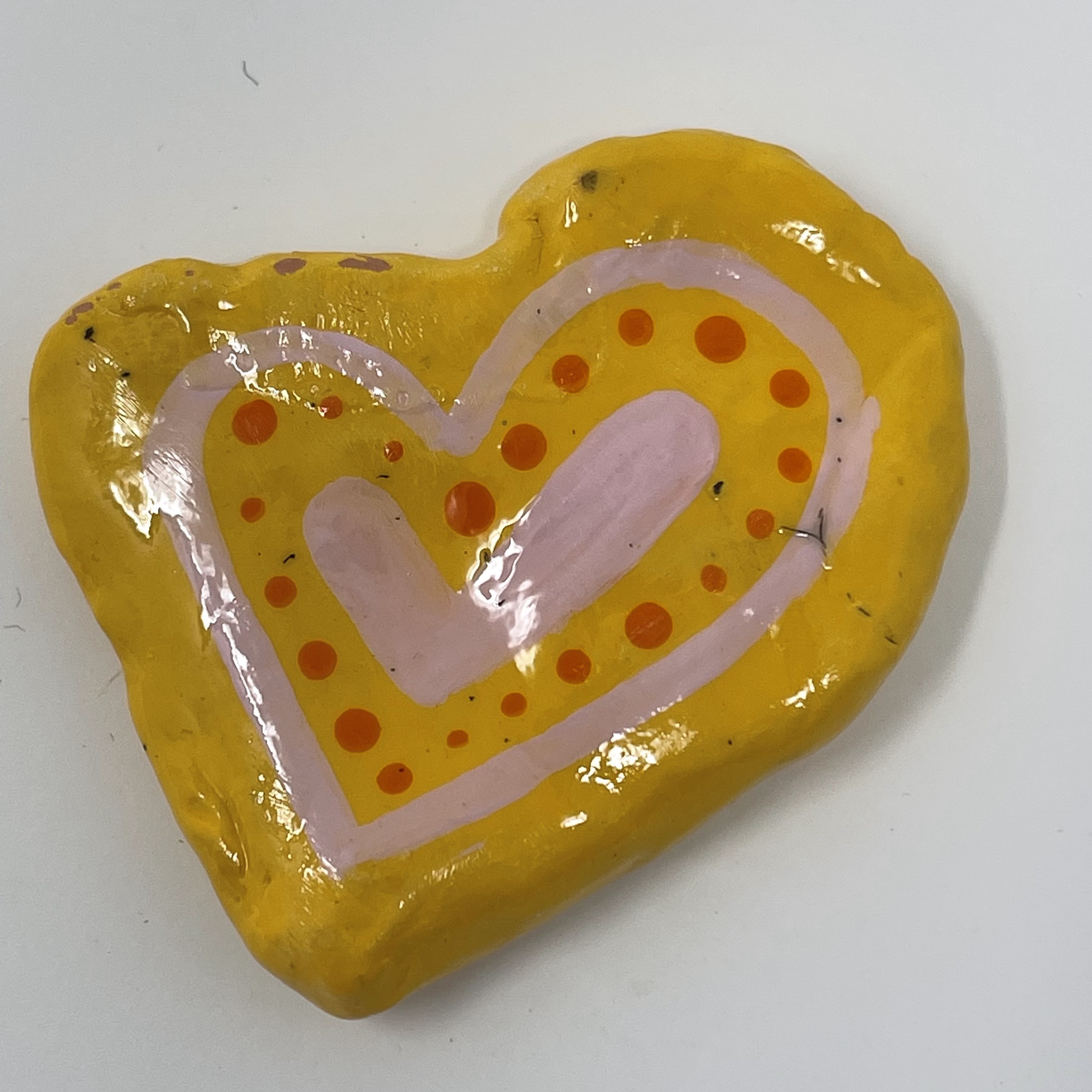 #56 Glazed clay heart. Yellow with orange circles and hearts. 2x2x0.5"