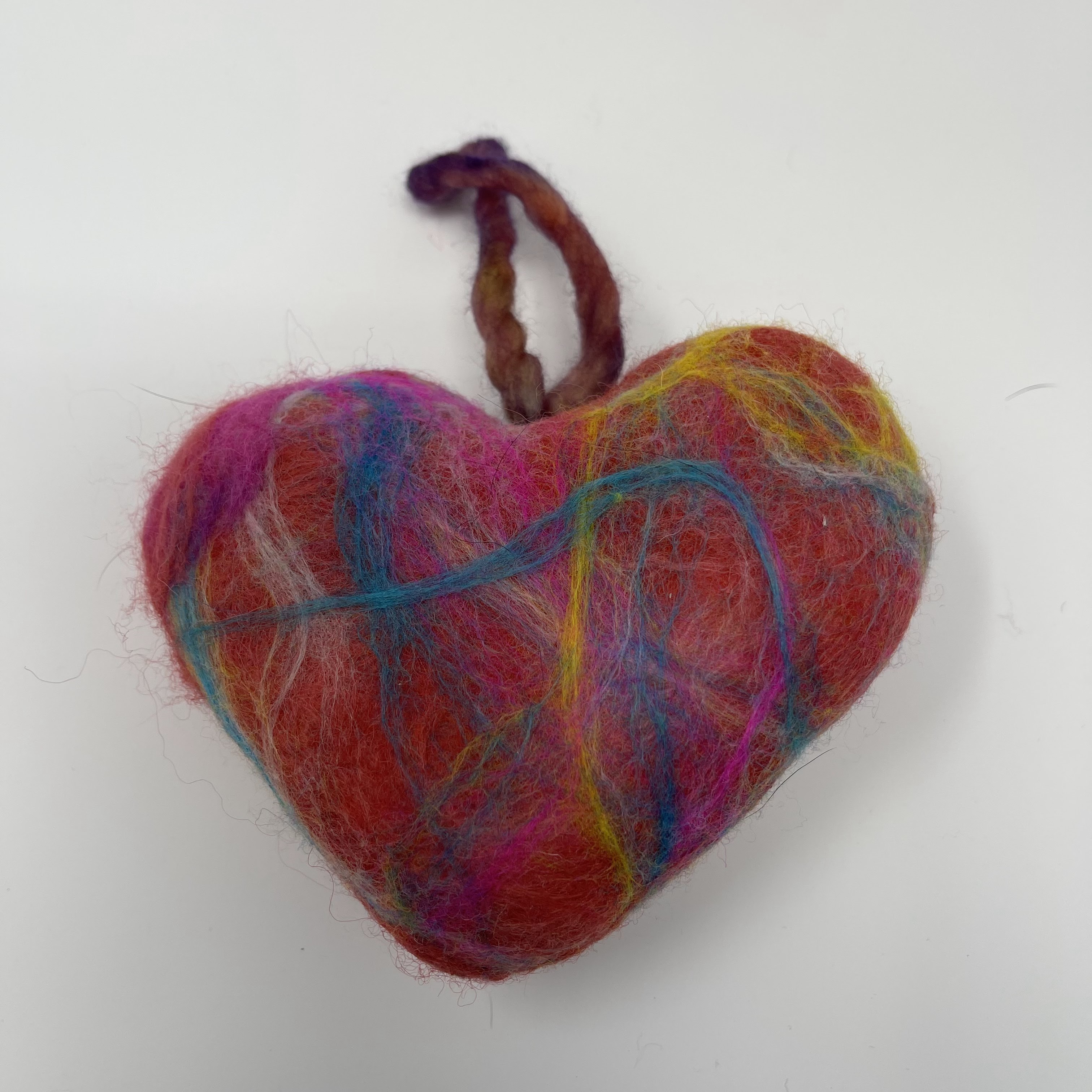 #57 Stuffed felted heart. Pink with swirls of yellow and blue. 5x6x2.5"