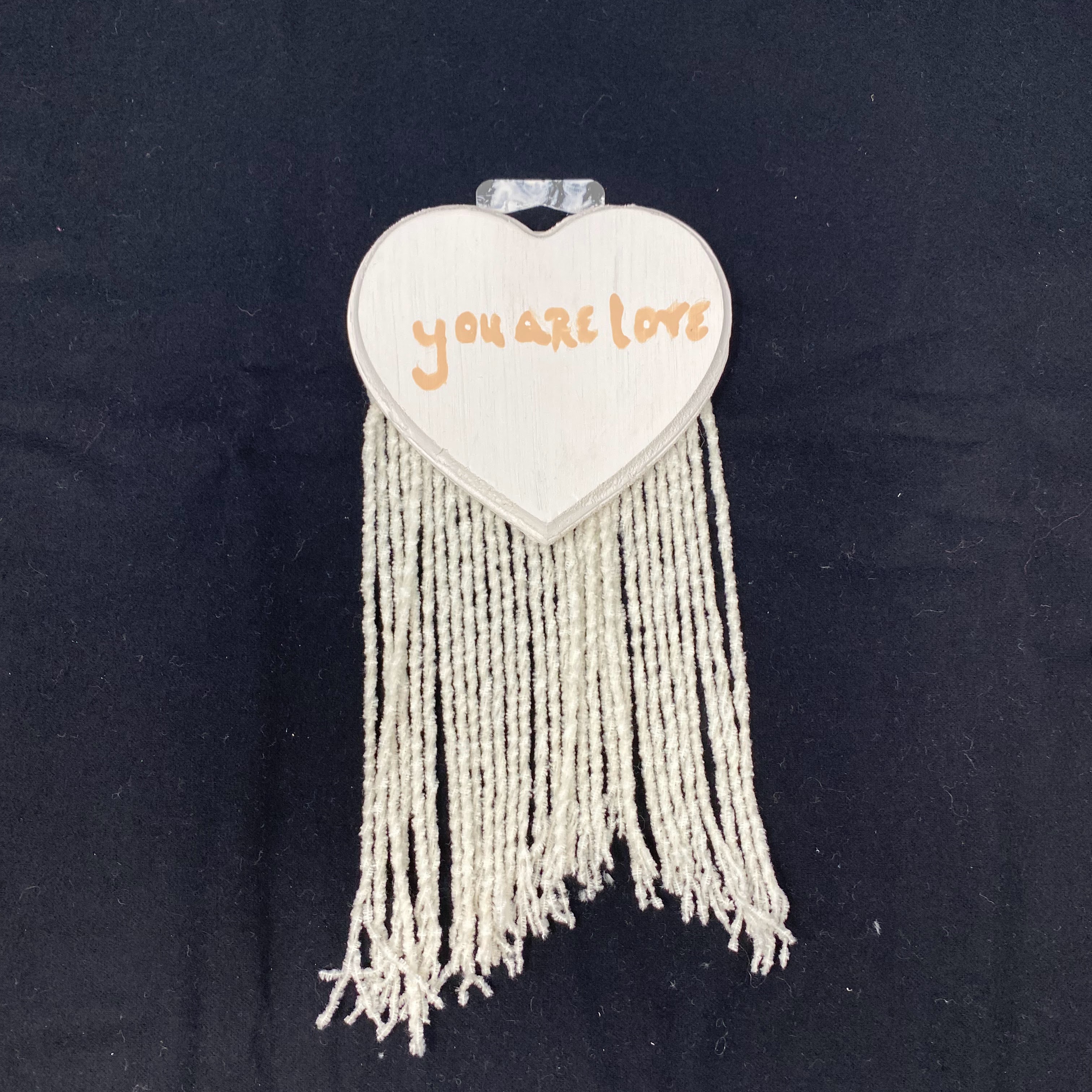 #63 Wood heart wall hanger with white fringe with you are loved message