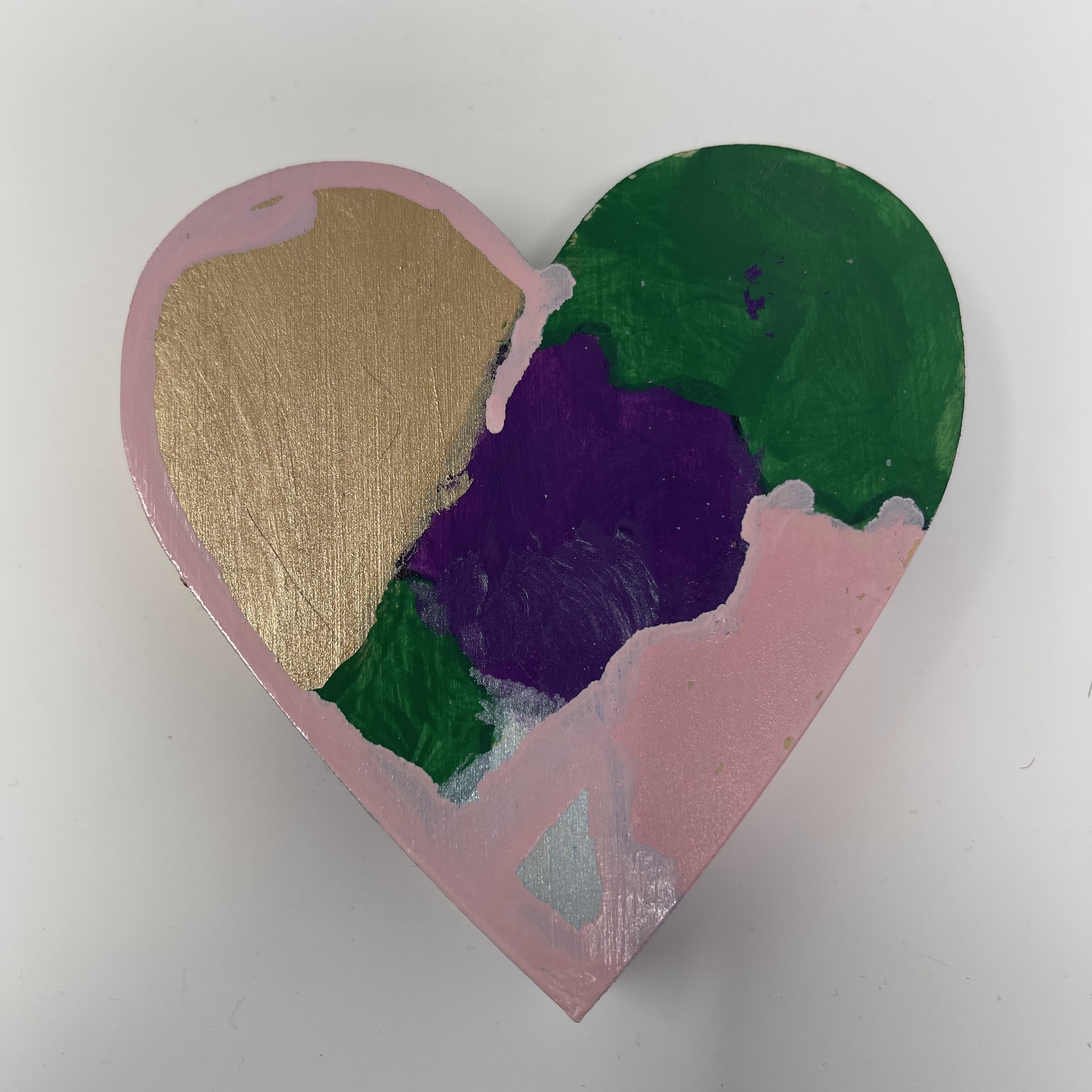 #65 Wood heart with greed, gold, silver, pink, and purple camoflauge. 4x4x1"